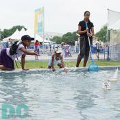 Kids try to create waves to send these boats on their way. 
