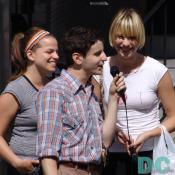 Two young ladies enjoy this talented friend's voice.