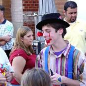 This clown pleased the children by making animal ballons.