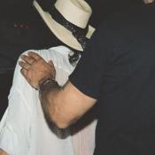 Steven Tyler's bodyguard rushes him to his limo.