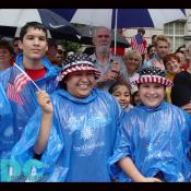 A family stands in excitement as the parade marches in front of them.