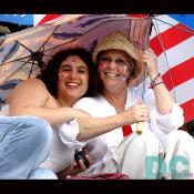 A mother and daughter stake out their spot on the Mall, sheltered by their umbrellas.