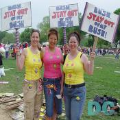 Three Pro-Choice activists hold up their demonstration signs - BUSH, STAY OUT, OF MY BUSH. The three women designed shirts with a picture outline of a female body with flowers covering the reproductive organs.