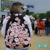 Female demonstrator with MOB (Mothers Opposing Bush) pinned to her daypack.