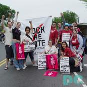 A group of students hold a ROCK THE VOTE! banner as well as signs reading FOR OUR FUTURE, FOR OUR FREEDOM, FOR OUR MOVEMENT -- YOUTH ARE PRO-CHOICE, QUEER RIGHTS ARE REPRODUCTIVE RIGHTS, and NO TRESPASSING - MY BODY IS NOT PUBLIC PROPERTY.