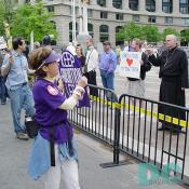 Marchers proclaim KEEP ABORTION LEGAL while Pro-Life onlookers, including a minister, ask sign readers to OPEN YOUR [heart] TO THE TRUTH.