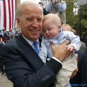 Baby Luke and Joe bump heads.