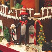 Dr. Suess' The Cat and the Hat plays in the yard of the gingerbread house.