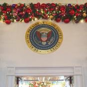 The official seal of the President stands before all in the State Dining Room.