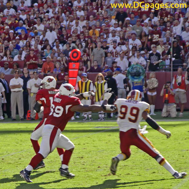 Andre Carter tries to swing around Mike Gandy to get Kurt Warner.