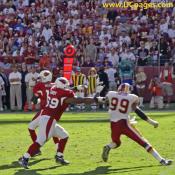 Andre Carter tries to swing around Mike Gandy to get Kurt Warner.