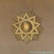 Bronze nine pointed star. Upon close examination there are three interlaced triangles. 