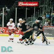 Steve Eminger clears the front of Olie Kolzig's crease.