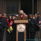 DC Vote Executive Director, Ilir Zherka, is watched closely by DC Congresswoman Norton as he addresses crowd before march to Capitol Hill to demand Congressional Voting Rights for DC residents. "The DC voting rights movement is like a rally race through time, with each generation passing the baton to the next generation."