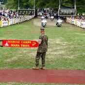Two marines await the arrival of the first Marathon runner.