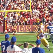 The ball is loose thanks to a bone-jarring hit by Redskins DE Andre Carter.
