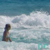 hot blonde girl playing in the caribbean surf