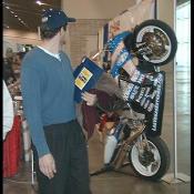 If you look closely at the bike, you can see a roll cage going around it's fairing.