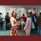A Native American clad in traditional American Indian clothing discusses the history of his tribe.