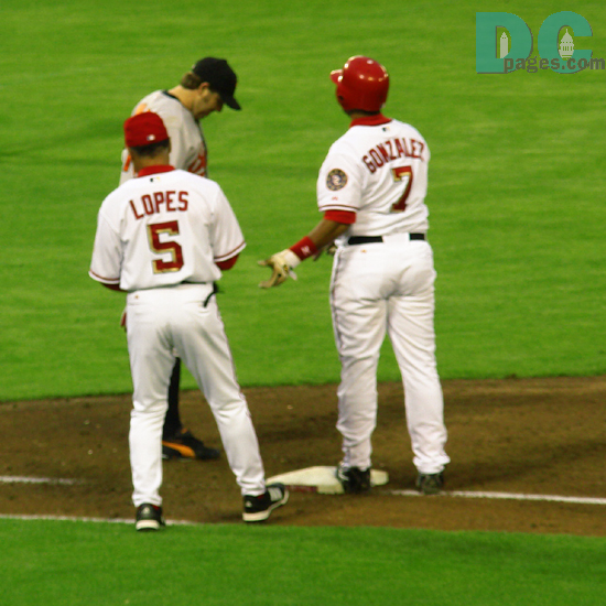 Washington Nationals catcher Wiki Gonzalez talks with the first base coach after hitting a single. For the night Gonzalez was 1-4.