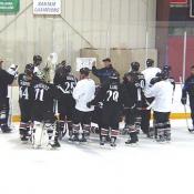 Players gather around to listen to instructions from the coaching staff.
