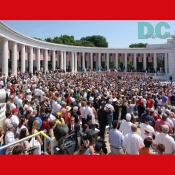 West view of the fully occupied amphitheater at Arlington National Cemetery .