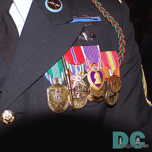 Heroes Red White and Blue Ball. Wounded Servicemember. Bronze Star, Purple Heart, and other honored medals.