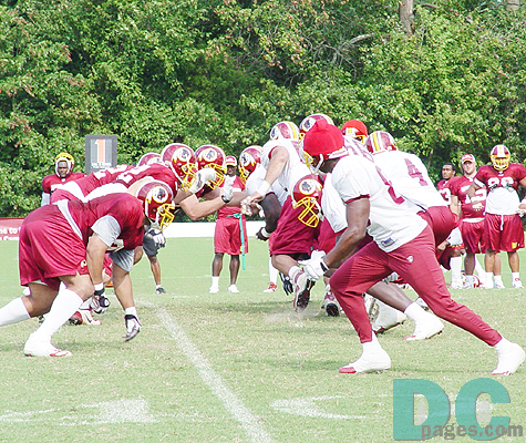 The defense and offensive line up against each other for some light contact drills.