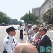 Processional watchers are greeted by the increased security along the motorcade route.