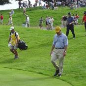 A golfer and his caddy walking to the next hole
