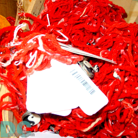 A close up of the red yarn offerings used in Haitian religious ceremonies.