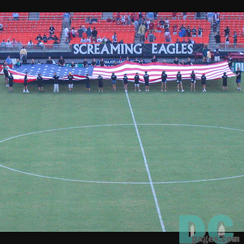 The U.S. Flag being presented onto the field for the opening to the game.