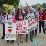 Pro-Choice signs - I LOVE CONDOMS - I SHOULD NOT HAVE TO BE HERE - THIS IS WHAT A FEMINIST LOOKS LIKE.The Capitol building is in the background.