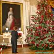 White House staff member adjusts paintings before the arrival of the First Lady. Painting of Martha Washington in the background.