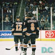 Jeff Friesen and Alex Ovechkin skate off to the bench.