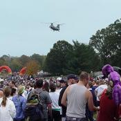 The CH-47D Chinook is a highly versatile heavy-lift helicopter. Its primary missions range from troop movements and artillery emplacement to battlefield resupply. This Chinook surveys the crowd.    