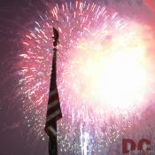 Home of the brave! The eagle soars over the American Flag. Fireworks