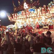 A crowd is forming around the Himalaya amusement ride.