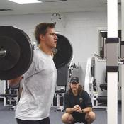 Jim Fox watches to make sure Zubrus is using the correct form during his scwats exercise.