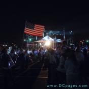 A veteran wearing a 'Rolling Thunder' jacket proudly waves his American flag.