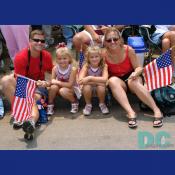 This family is well dressed to watch the parade.