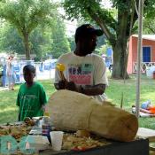 This Haitian drummaker shows festival goers what it takes to make an authentic drum by hand.