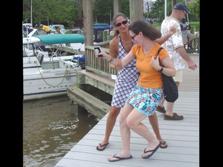 Oh no, she's going to push her sister in the water.
