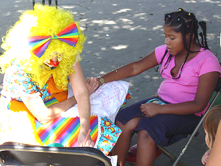 Clowns were painting arms, legs, and faces at the Children's Fair.