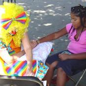 Clowns were painting arms, legs, and faces at the Children's Fair.