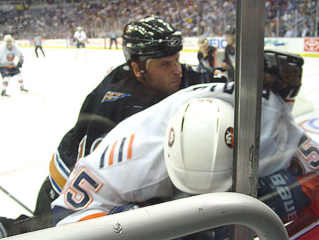 Brendan Witt begins the 2003 season by slamming Islanders Jason Blake into the boards.