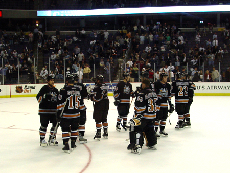 Caps players congratulate themselves after a great team effort in defeating the Islanders.