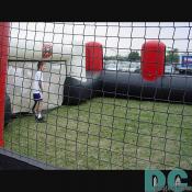 Big air filled mini stadium has this kid playing goal keeper against his friends.