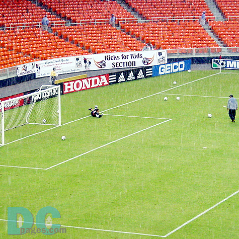 The rain doesn't stop the DC United goal keeper from practicing hard before tonights match.