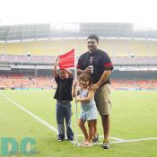A family was posing in front of a corner flag, a good spot for taking pictures before the game started. 